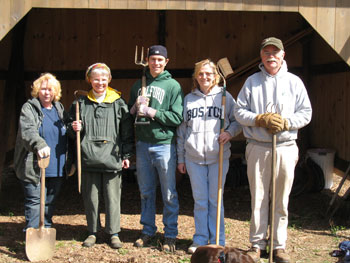 Group of gardeners in front of garden shed